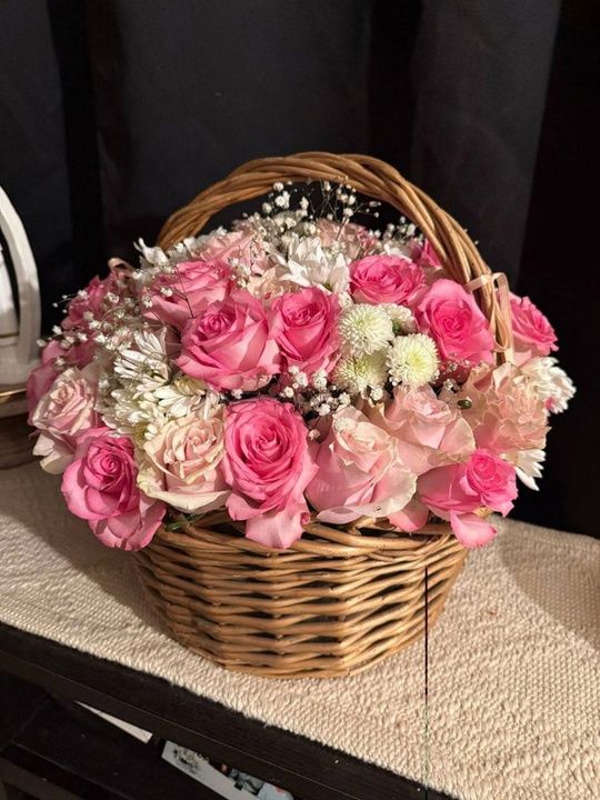 Flower basket with pink roses, mums and baby's breath