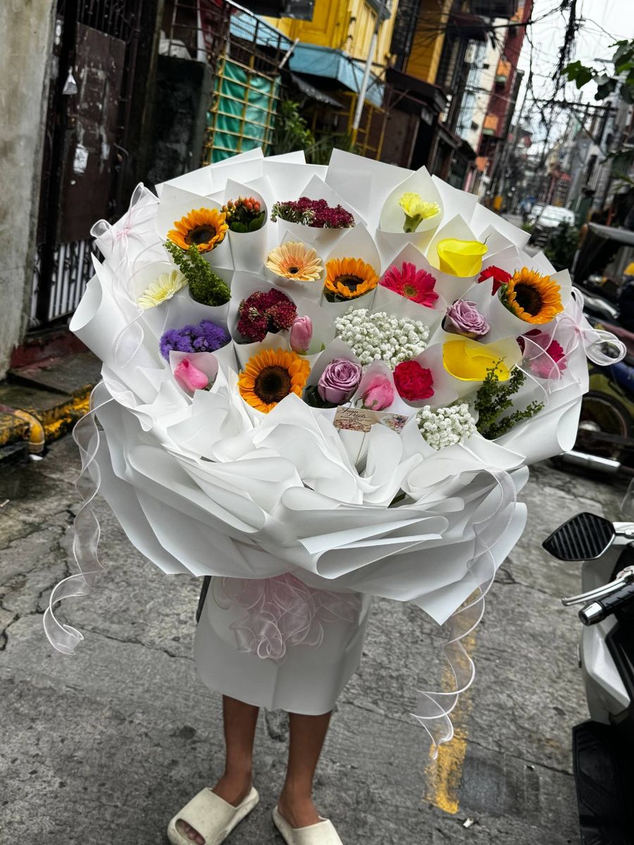 Omakase mixed flower bouquet with assorted seasonal flowers in white wrap