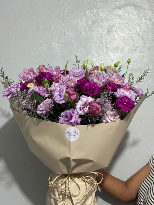 Purple lisianthus bouquet with carnations, roses and kraft wrap