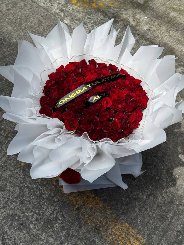 Red rose bouquet in white wrapping