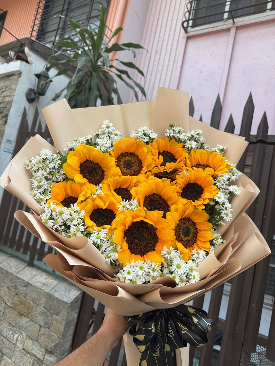 Sunflower bouquet with white daisy accents in kraft wrap