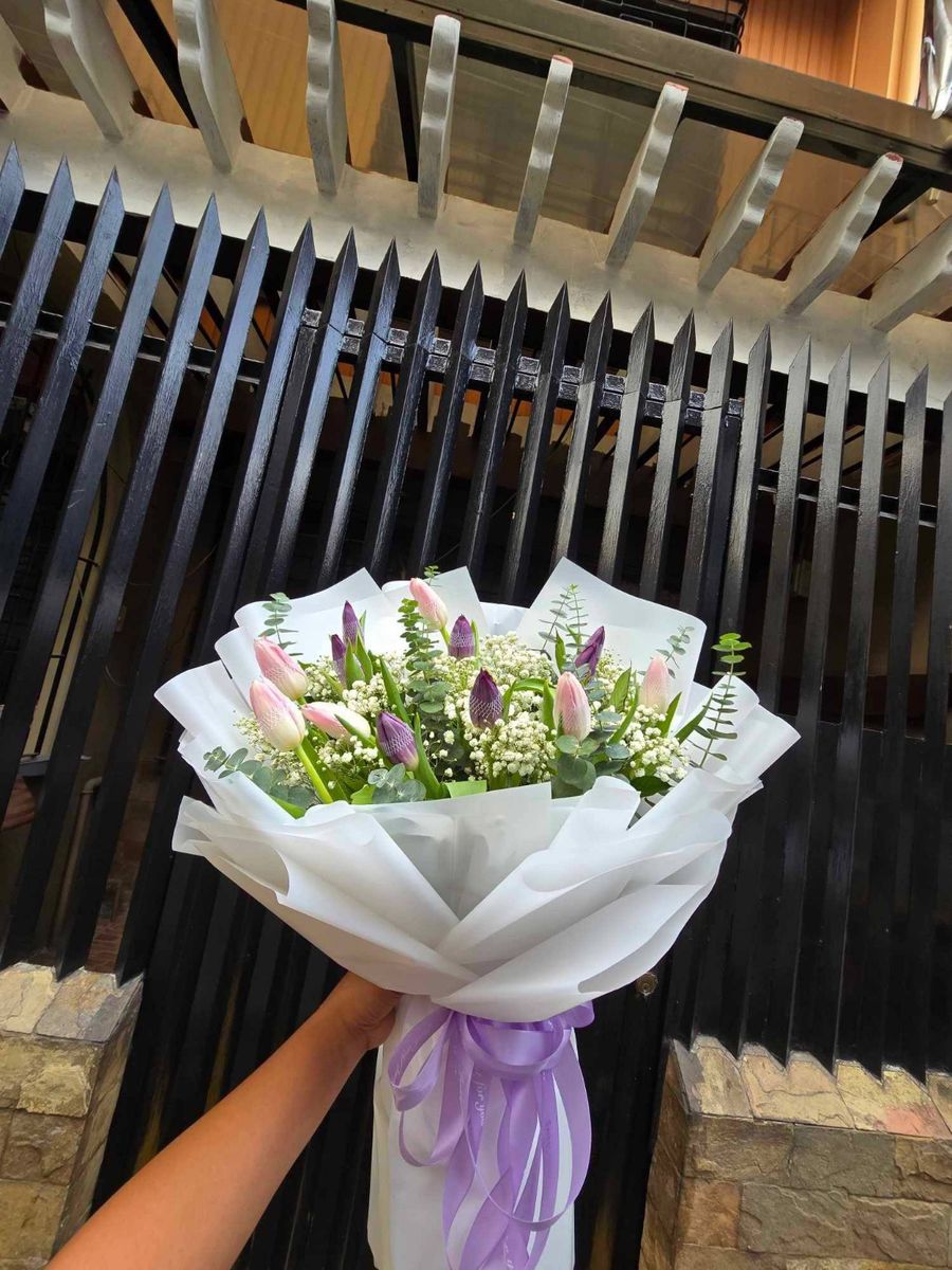 Pink and purple tulip bouquet with baby's breath and eucalyptus greenery
