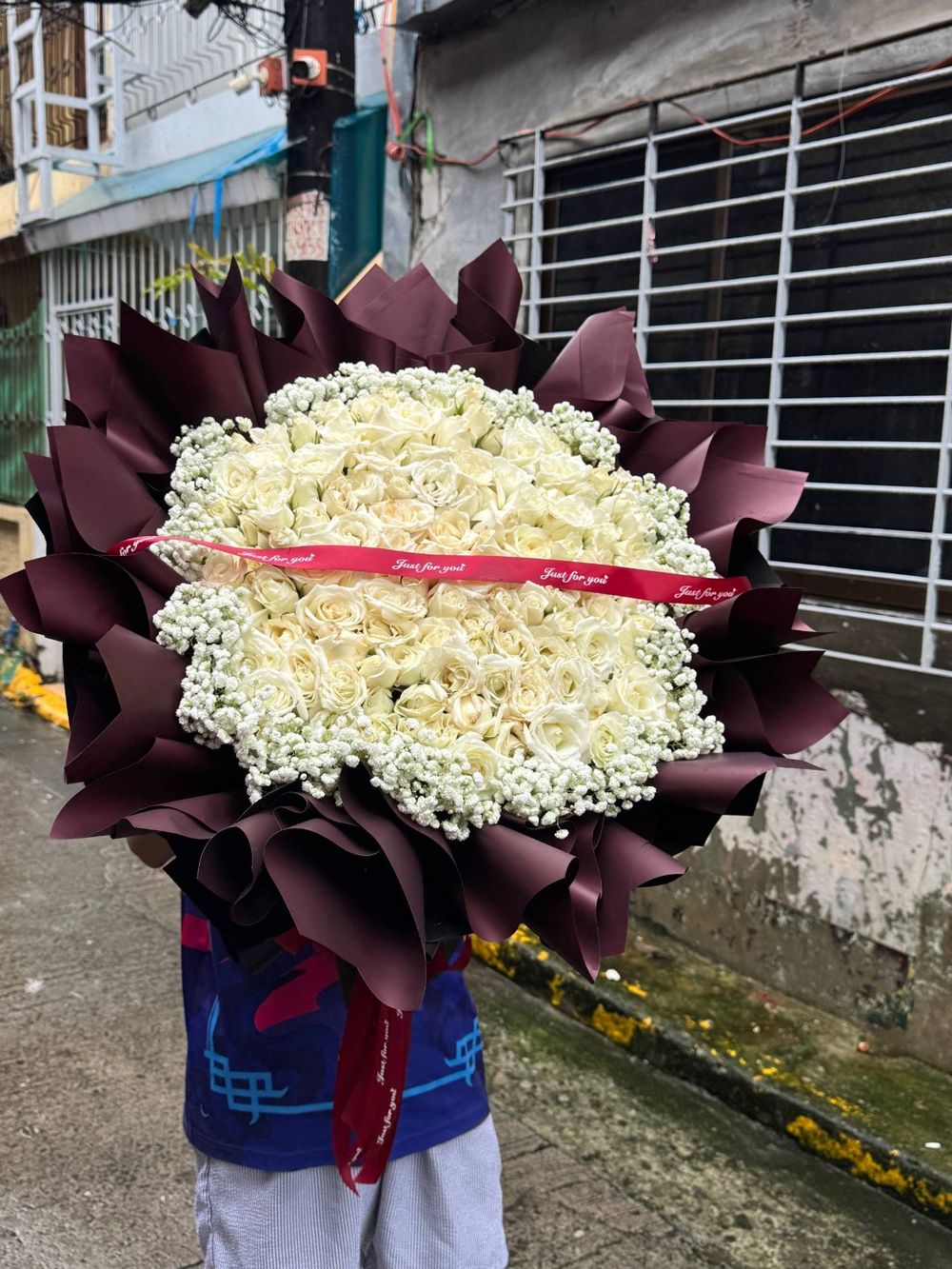 White rose bouquet with burgundy wrapping