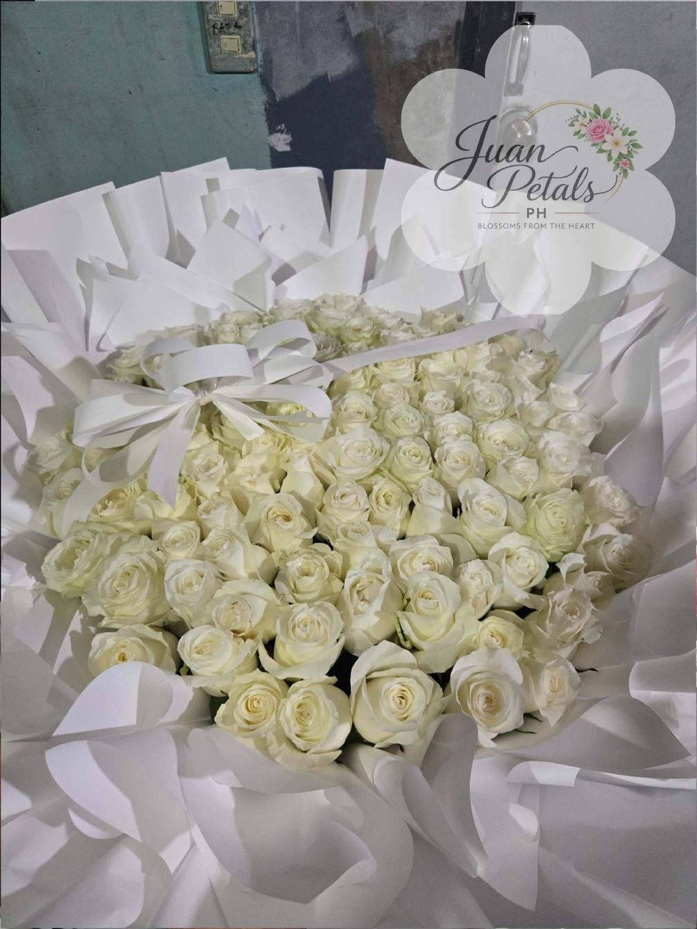Colorful Juan Petals signature bouquet with pink, blue and white flowers