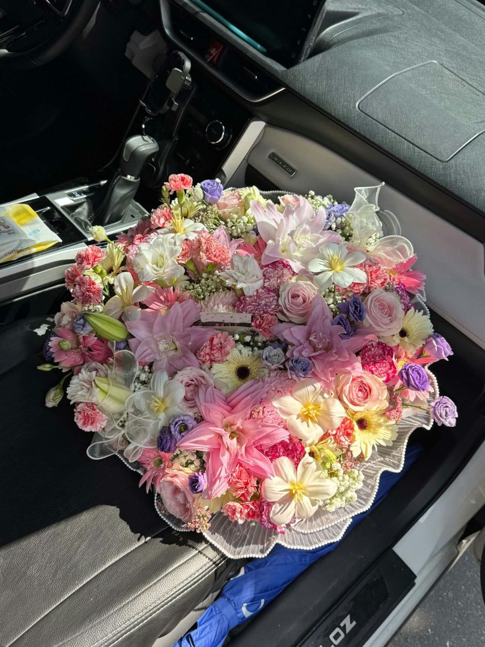 Fresh Juan Petals bouquet photographed in a car